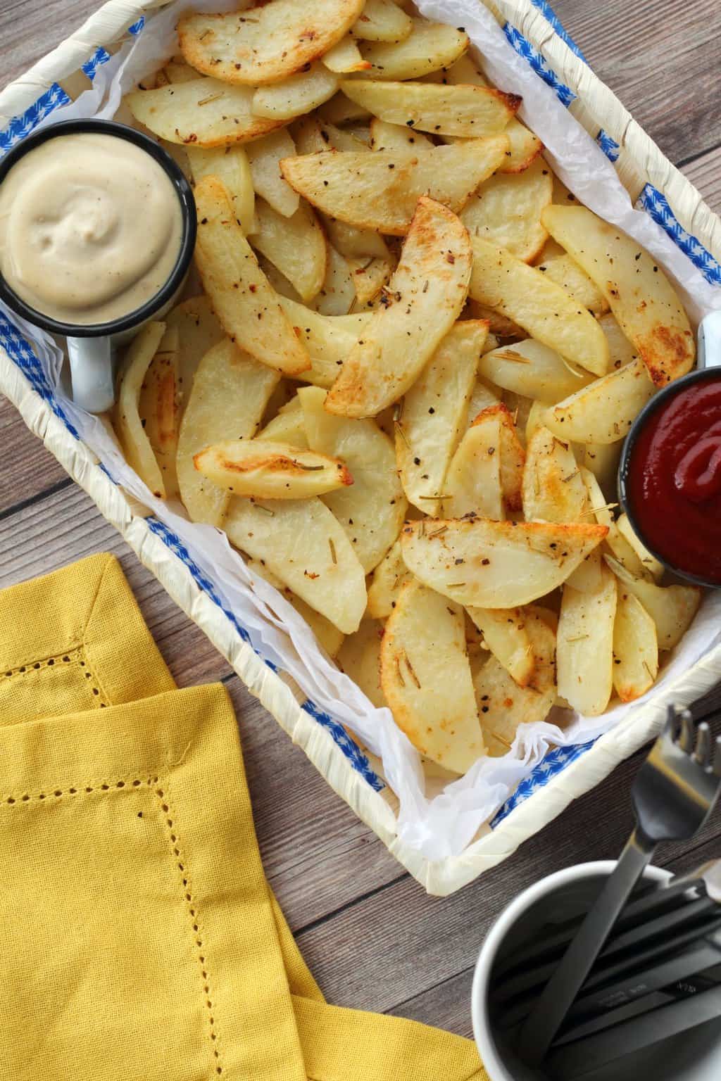 Baked Potato Fries in a basket with cashew sour cream and ketchup.