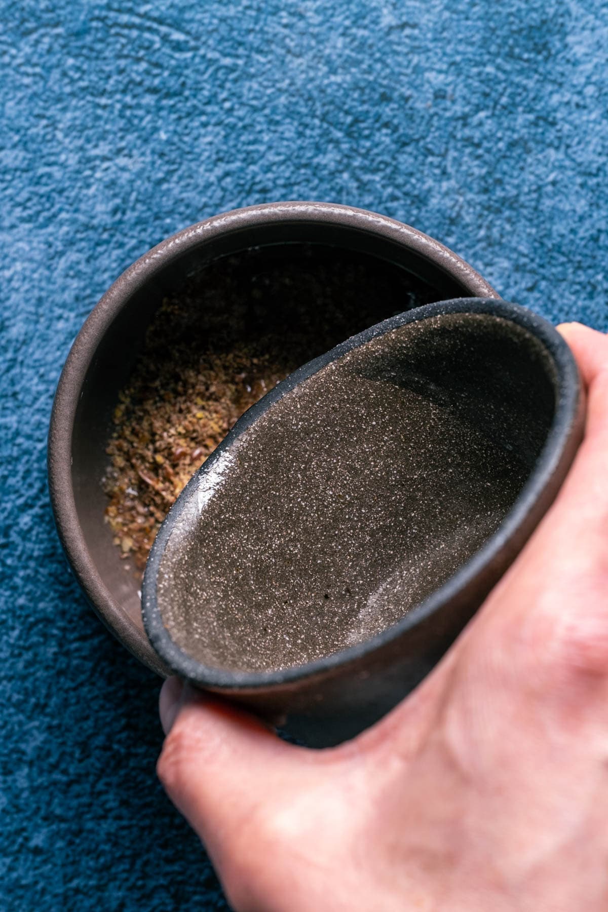 Photo of adding hot water to the ground flaxseeds in a bowl.