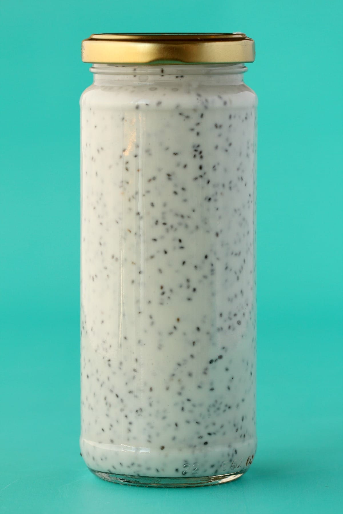 A mason jar filled with chia seeds and coconut cream.