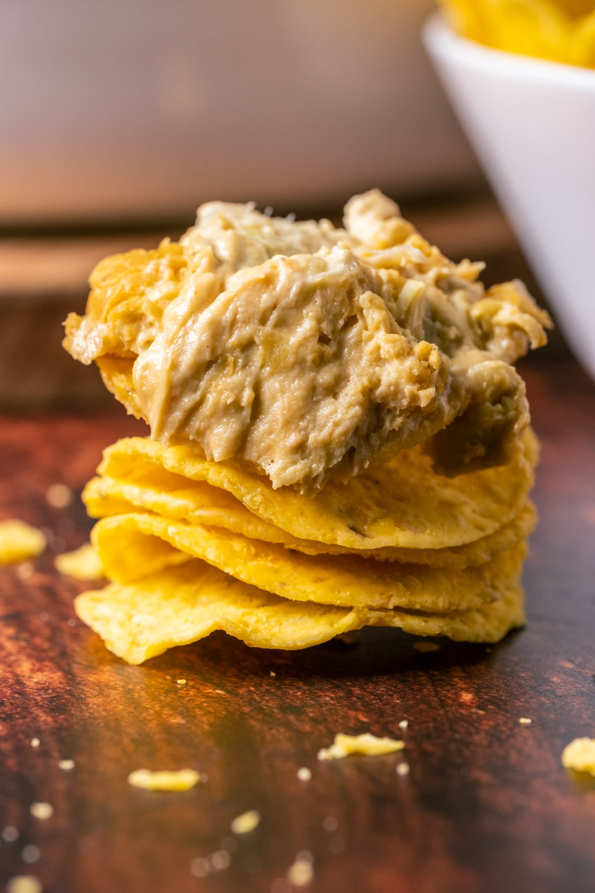 Stack of chips topped with vegan buffalo dip.