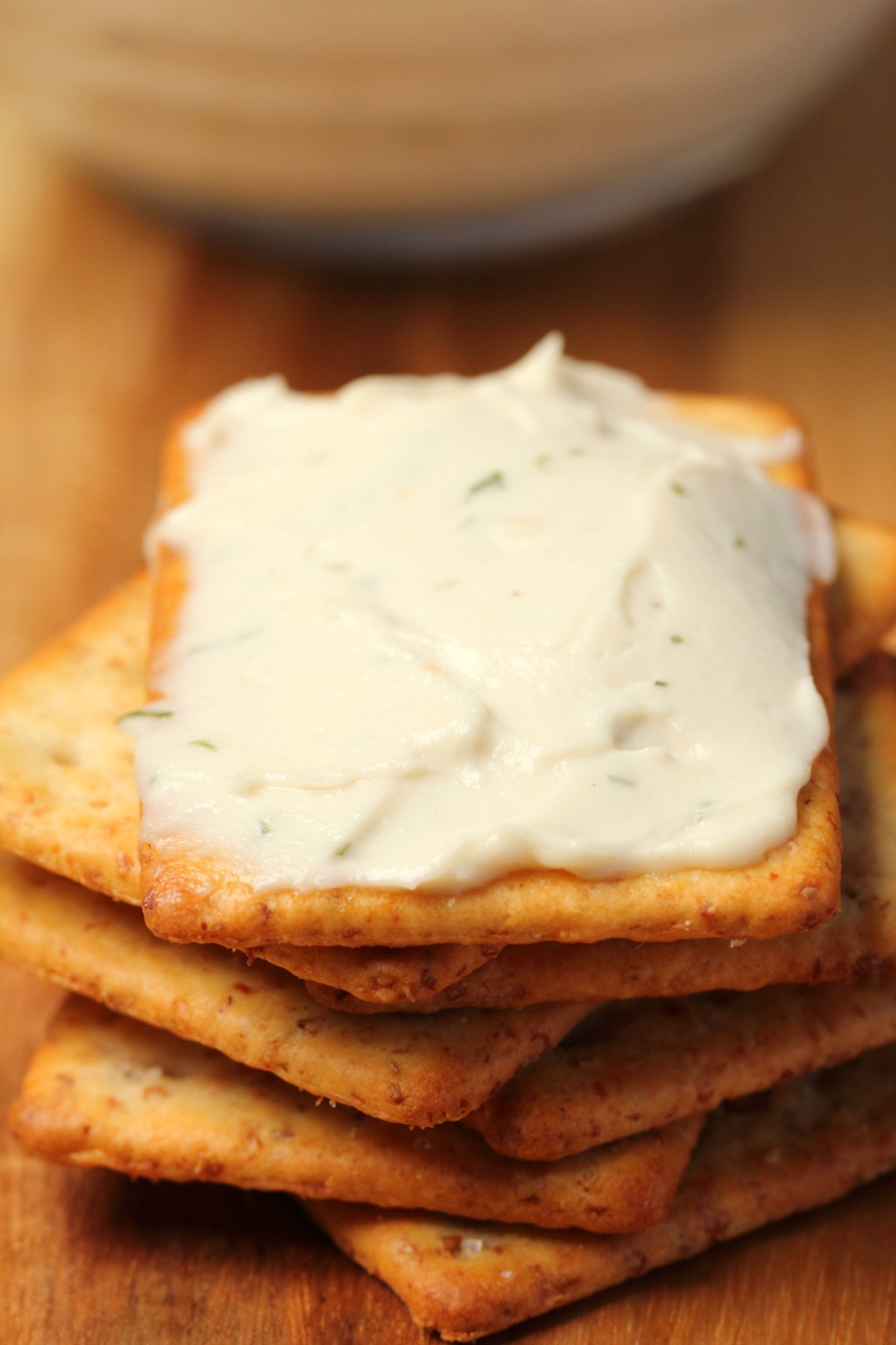 A stack of crackers topped with vegan cream cheese. 