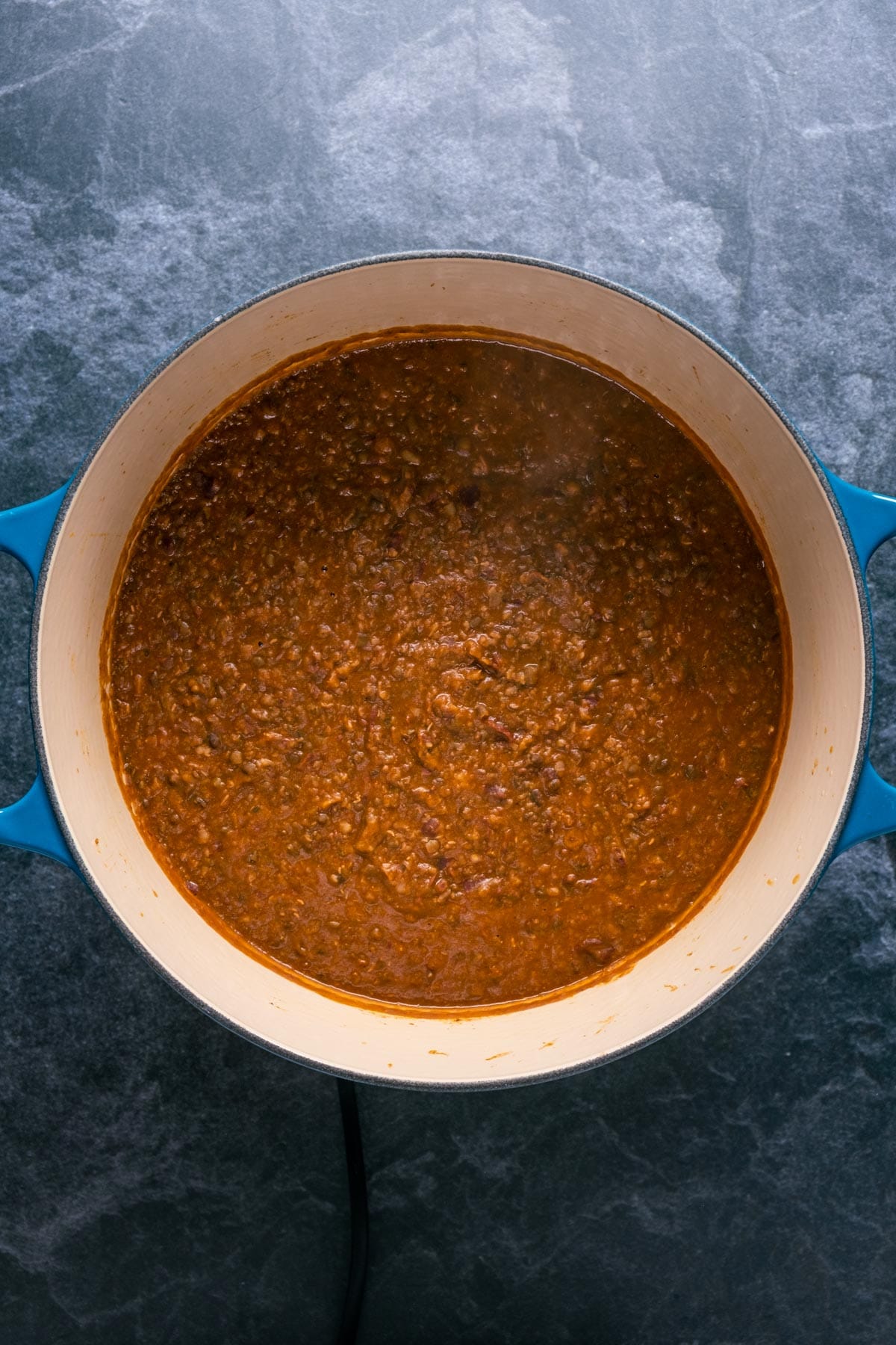 Dal makhani cooking in a pot.
