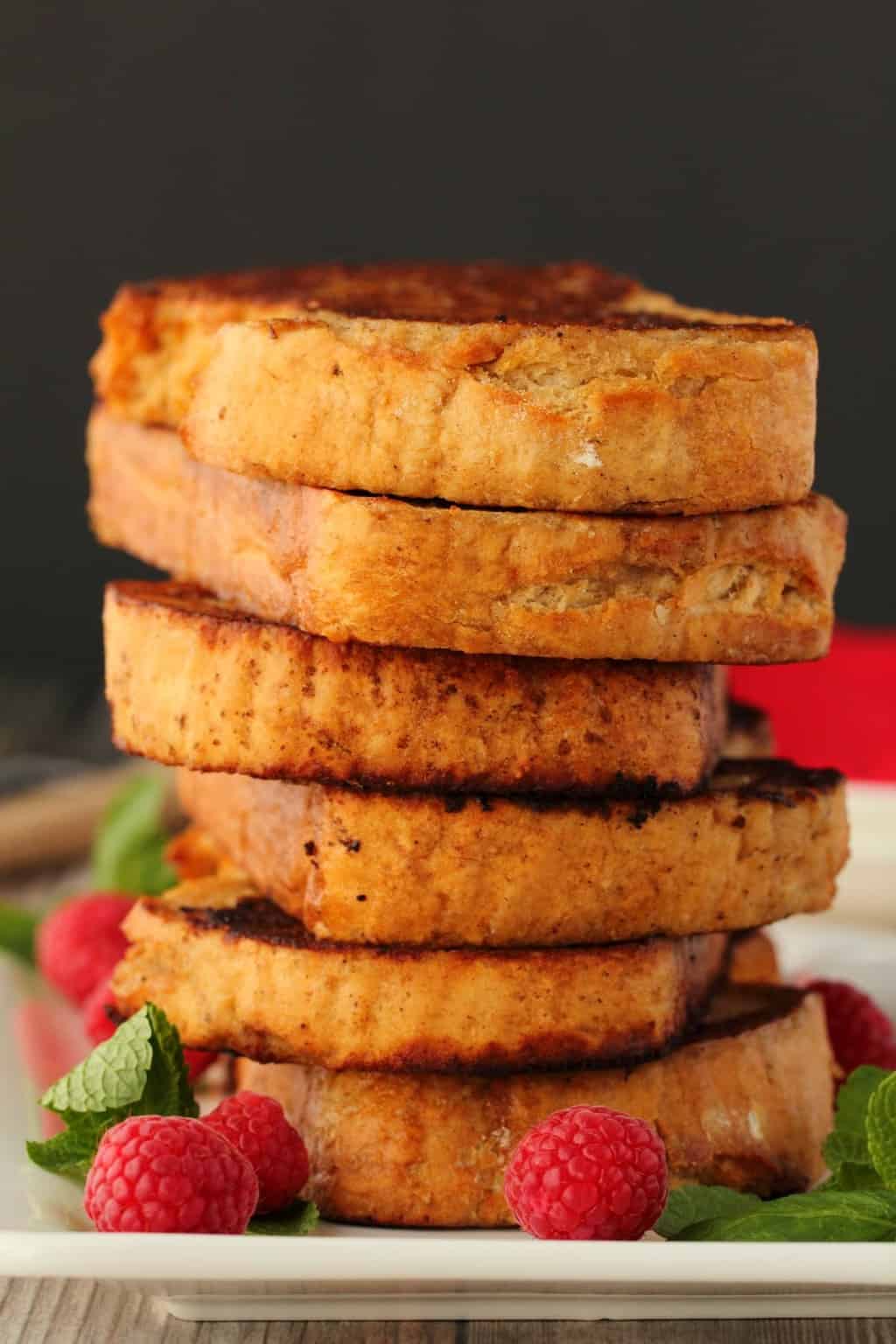 A stack of vegan french toast on a white plate. 