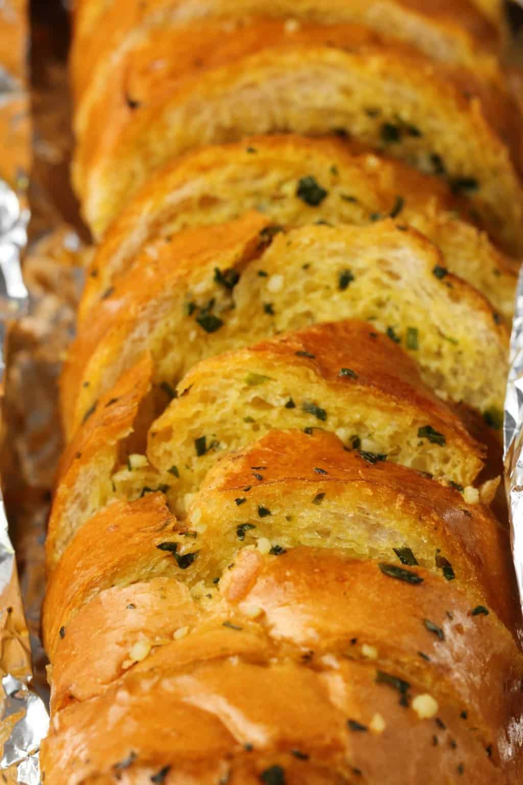 Freshly baked vegan garlic bread in tinfoil. 