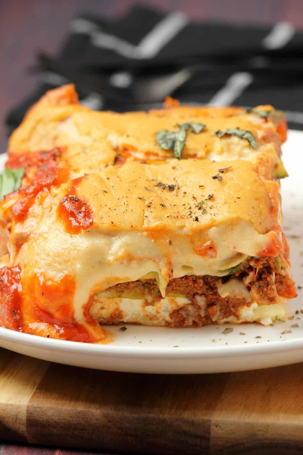 A slice of vegan lasagna on a white plate. 