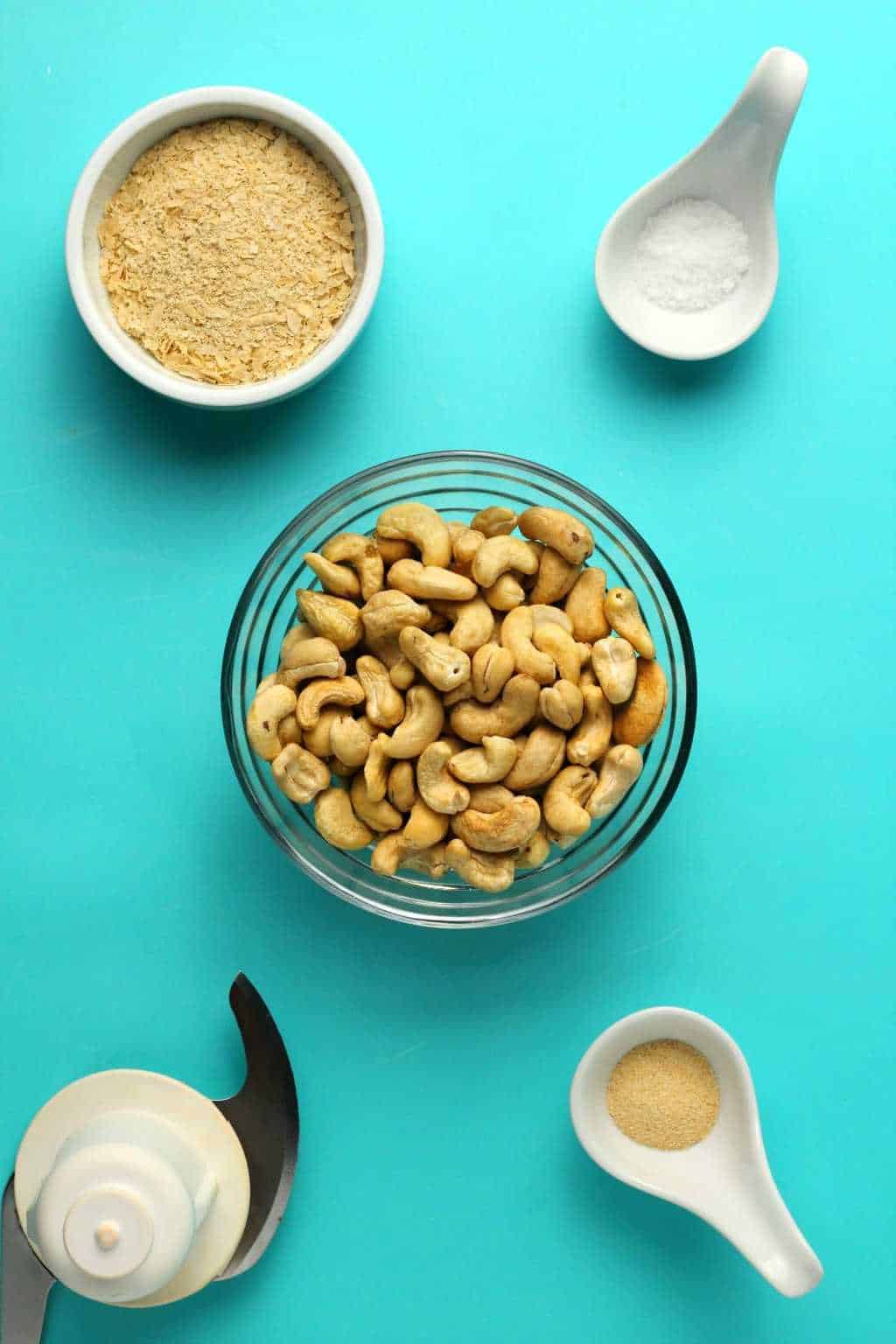 Ingredients to make vegan parmesan cheese, cashew nuts, nutritional yeast, salt and garlic powder. 