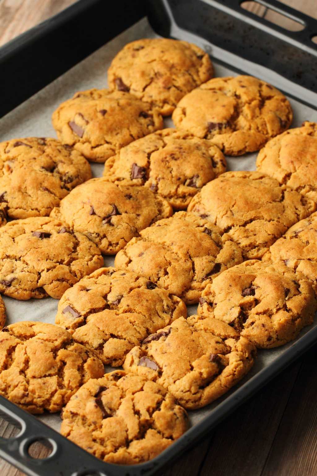 Vegan Peanut Butter Chocolate Chip Cookies on a baking tray straight out of the oven. 