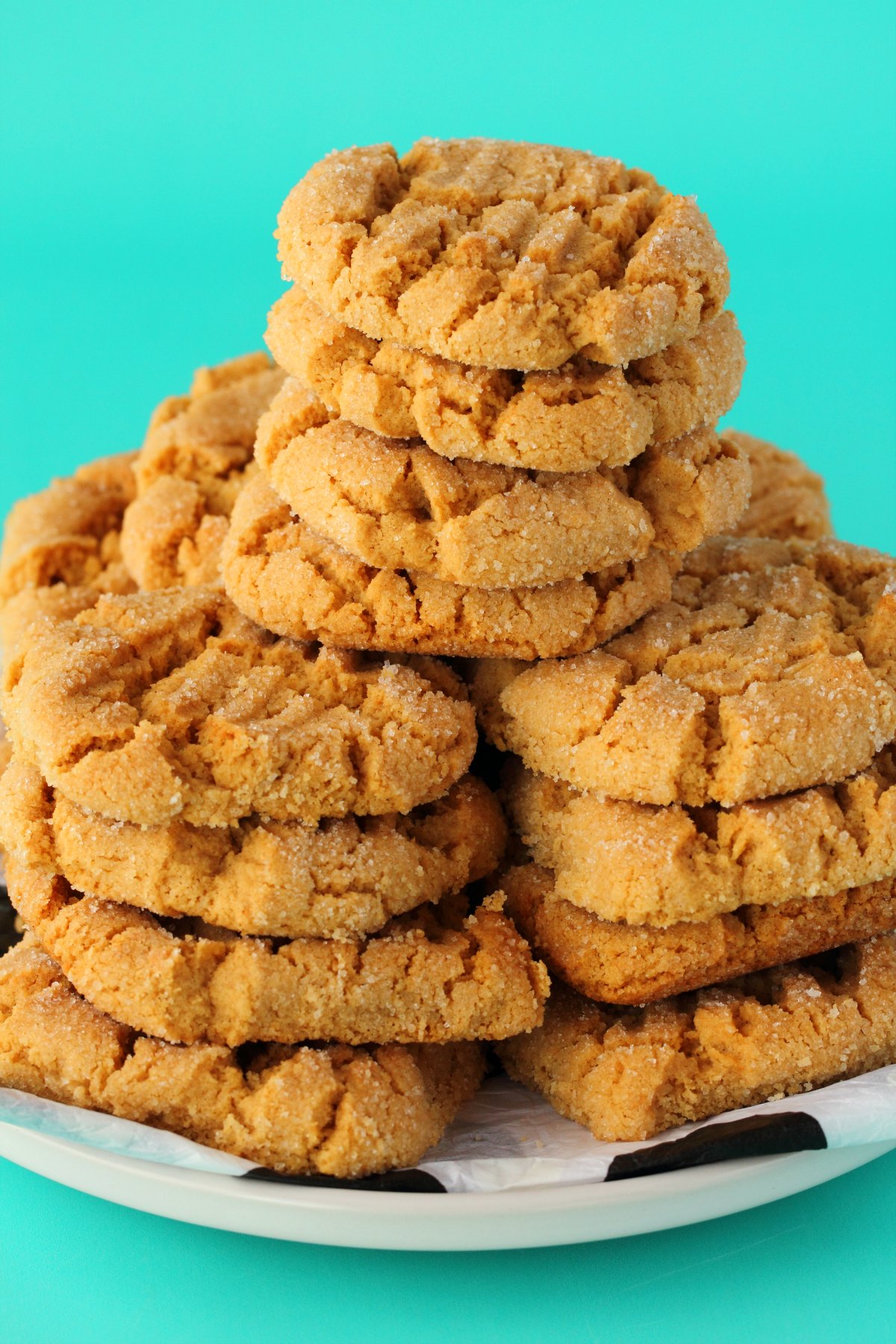 Cookies stacked up on a white plate. 
