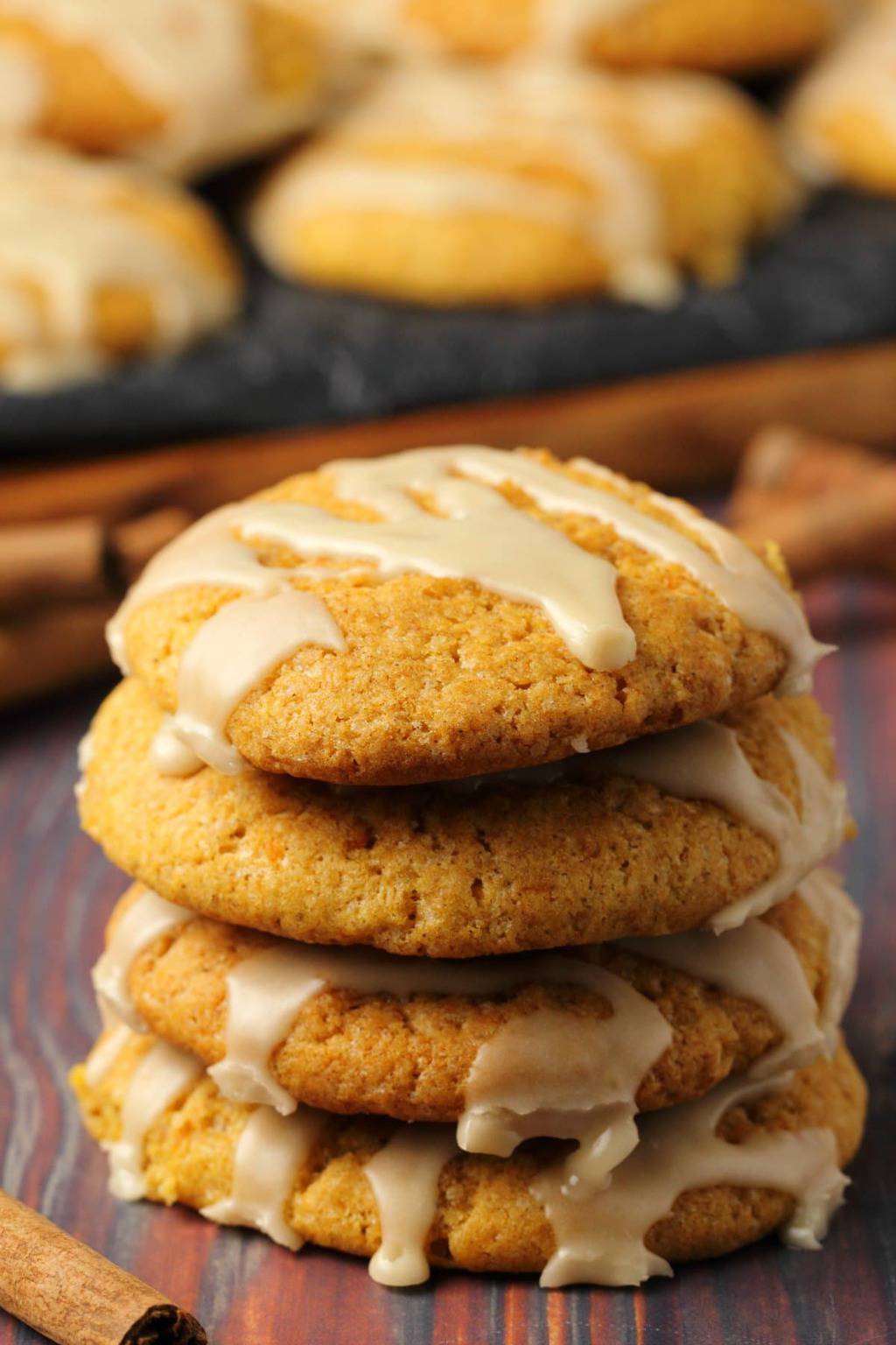 A stack of vegan pumpkin cookies topped with maple glaze. 