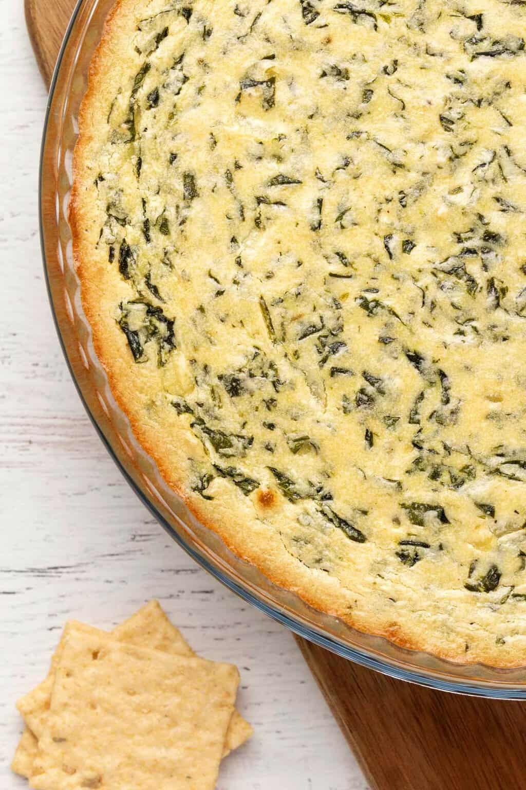 Vegan spinach dip in a round glass dish. 