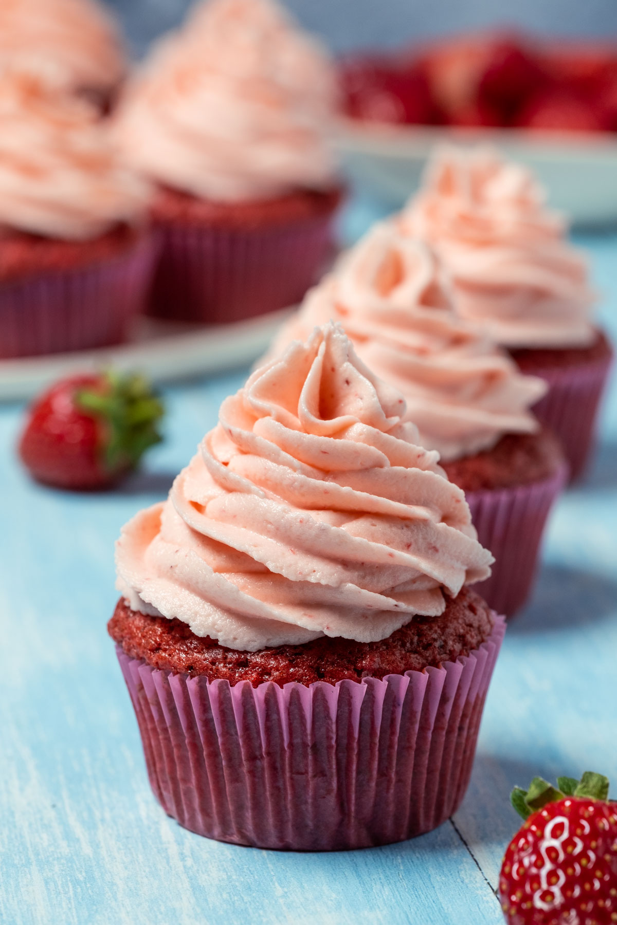 Vegan strawberry cupcake in a row.